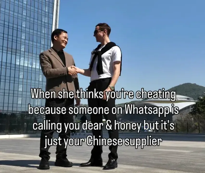 Two men shaking hands outside a glass office tower, captioned: when she thinks you're cheating because someone on Whatsapp is calling you dear and honey but it's just your Chinese supplier